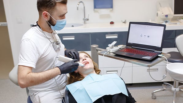 dentist digitally scans patient's mouth